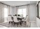 Elegant dining room with a table for six, and stylish patterned curtains at 7304 Sw 107Th Ln, Ocala, FL 34476