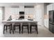 Modern kitchen with white cabinets, stainless steel appliances and an island with seating at 7304 Sw 107Th Ln, Ocala, FL 34476