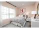 Charming bedroom with pink walls, queen bed, and stylish decor at 7416 Sw 107Th Ln, Ocala, FL 34476