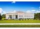 One-story home with white exterior, landscaping, and two-car garage at 7416 Sw 107Th Ln, Ocala, FL 34476