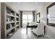 Home office with built-in shelving, desk, and comfortable chair at 7416 Sw 107Th Ln, Ocala, FL 34476