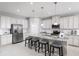 Modern kitchen with white cabinets, granite countertops, and stainless steel appliances at 7416 Sw 107Th Ln, Ocala, FL 34476