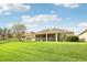 Spacious backyard with lush lawn and screened patio at 5631 Superior Dr, Lakeland, FL 33805