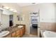 Double vanity bathroom with access to the bedroom and walk-in closet at 5631 Superior Dr, Lakeland, FL 33805