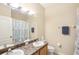 Bathroom with double vanity, shower, and tile floor at 5631 Superior Dr, Lakeland, FL 33805
