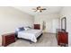Main bedroom with king bed, dresser, and ceiling fan at 5631 Superior Dr, Lakeland, FL 33805