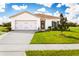 One-story home with attached garage and manicured lawn at 1657 Laia Rd, Haines City, FL 33844
