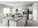 Open kitchen with island, granite countertops, and stainless steel appliances at 1657 Laia Rd, Haines City, FL 33844