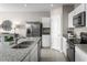 Modern kitchen with white cabinets, granite counters, and stainless steel appliances at 1657 Laia Rd, Haines City, FL 33844