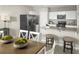 Kitchen features island with seating, granite counters, and stainless steel appliances at 1657 Laia Rd, Haines City, FL 33844