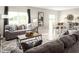 Open living and dining area with gray sofas and tile floors at 1657 Laia Rd, Haines City, FL 33844