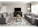 Spacious living room with gray sofas and patterned rug at 1657 Laia Rd, Haines City, FL 33844