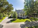 Stone house with driveway and manicured lawn at 3923 Nw 85Th Ter, Ocala, FL 34482