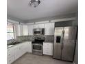 Kitchen with stainless steel appliances and white cabinets at 1500 32Nd Nw St, Winter Haven, FL 33881