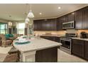 Modern kitchen with granite countertops and stainless steel appliances at 177 Bella Verano Way, Davenport, FL 33897