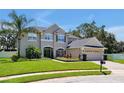 Two-story house with green shutters, landscaping, and a paved driveway at 517 Zinfandel Ct, Ocoee, FL 34761