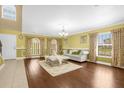 Bright living room with hardwood floors, a comfy sofa, and a chandelier at 11407 Bentry St, Orlando, FL 32824