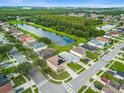 Aerial view of a beautiful house in a residential neighborhood with a lake at 11407 Bentry St, Orlando, FL 32824