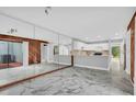 Open dining area with marble flooring and access to the patio at 1502 Ne Buckeye Ne Rd # 2, Winter Haven, FL 33881
