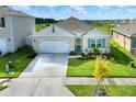 Single-story home with a two-car garage and well-manicured lawn at 2638 Galway Grove Way, Lakeland, FL 33811