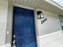 Stylish blue front door with updated hardware and house number at 2808 Fletcher Ave, Lakeland, FL 33803