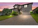 Two-story house exterior at dusk with landscaping at 4227 Prima Lago Dr, Lakeland, FL 33810