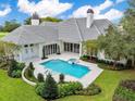 Luxury pool and spa with spacious patio and lush landscaping at 4015 Nw 85Th Ter, Ocala, FL 34482