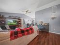 Living room with a sofa, TV, and fireplace at 5337 Jacob Ave, Polk City, FL 33868