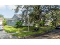 Gray house with landscaping and street view at 7036 Mapperton Dr, Windermere, FL 34786