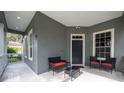 Front porch with seating area and entry door at 7036 Mapperton Dr, Windermere, FL 34786