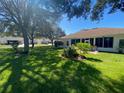Spacious backyard with lush lawn and landscaping at 24502 Parlange Ct, Leesburg, FL 34748