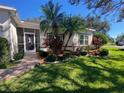 Landscaped entryway to a single Gathering home at 24502 Parlange Ct, Leesburg, FL 34748