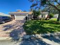 Single Gathering home with two-car garage and brick driveway at 24502 Parlange Ct, Leesburg, FL 34748