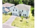 Aerial view of house, driveway and yard at 29912 Cypress Pointe, Deer Island, FL 32778