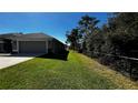 One-story home with gray exterior and landscaped yard at 9832 Sw 46Th Ct, Ocala, FL 34476