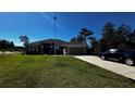 One-story home with gray exterior and landscaped yard at 9832 Sw 46Th Ct, Ocala, FL 34476