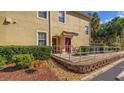 Condo building entrance with accessible ramp and landscaping at 2711 Oakwater Dr # 116, Kissimmee, FL 34747