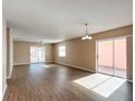 Spacious living area with hardwood floors and access to a patio at 611 Nuevo Leon Ln, The Villages, FL 32159