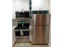 Modern kitchen with stainless steel appliances and white cabinets at 4005 Santa Maria Dr # 103, Kissimmee, FL 34741