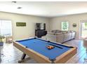 Spacious game room featuring a pool table and comfortable seating at 2905 Black Birch Dr, Ocoee, FL 34761