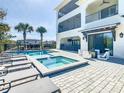 Luxury pool and spa with lounge chairs and outdoor patio at 550 Muirfield Loop, Reunion, FL 34747