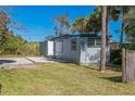 Side view of a mobile home, showing the entrance and a yard at 18925 3Rd Ave, Orlando, FL 32820