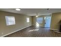 Bright and spacious living room with wood-look flooring and ample natural light at 7204 Peyton Pl, Orlando, FL 32818