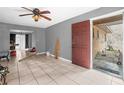 Living room with tile flooring, ceiling fan, and entry door at 4212 Harry Dr, Fruitland Park, FL 34731