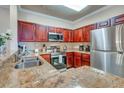 Kitchen with stainless steel appliances and granite countertops at 1301 Tuscan Ter # 9401, Davenport, FL 33896