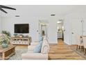 Living room features hardwood floors and kitchen view at 3800 Saxon Dr # C-52, New Smyrna Beach, FL 32169