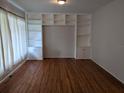 Bright living room featuring hardwood floors and built-in shelving at 2721 Woodland Hills Ave, Lakeland, FL 33803