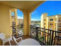 Balcony with table and chairs, offering scenic views of the resort at 8101 Resort Village Dr # 3303, Orlando, FL 32821