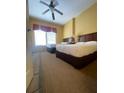 Well-lit guest bedroom with two double beds and ceiling fan at 8101 Resort Village Dr # 3303, Orlando, FL 32821