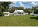 Spacious backyard with a large lawn, shed, and privacy fence at 815 E Church St, Bartow, FL 33830